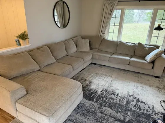 Large light beige fabric sectional sofa after upholstery cleaning in Brooke Bahr's living room