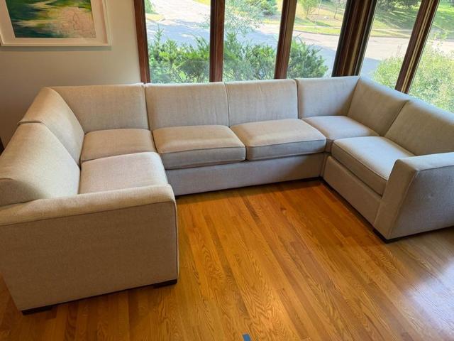 Light sectional sofa after upholstery cleaning in a customer’s sunny living room